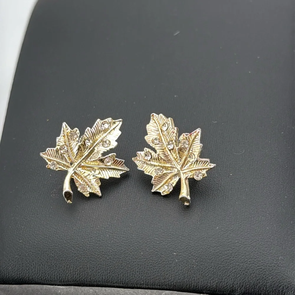 Gold tone textured leaf rhinestone accent screw back statement earrings